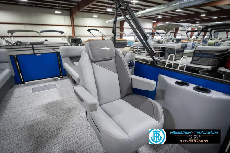 Slide: The Image of 2026 Bennington 25 SSR boat interior with gray seating in a showroom. - 27