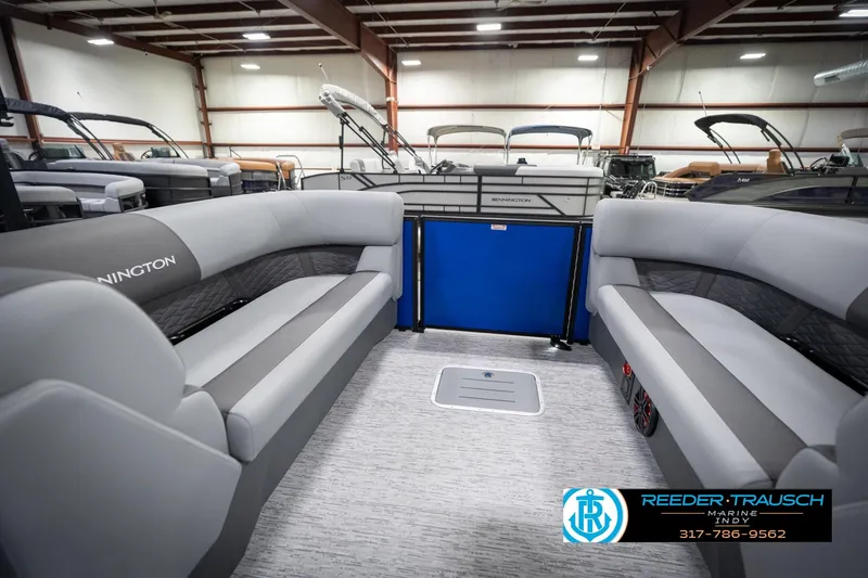 Slide: The Image of 2026 Bennington 25 SSR pontoon boat interior with gray seating in a showroom. - 28