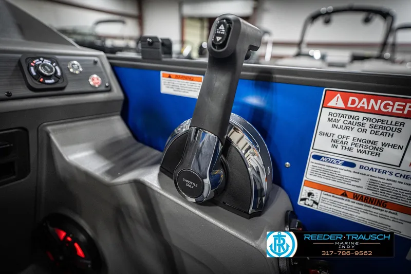 Slide: The Image of Control panel of 2026 Bennington 25 SSR boat with throttle and safety warnings. - 39