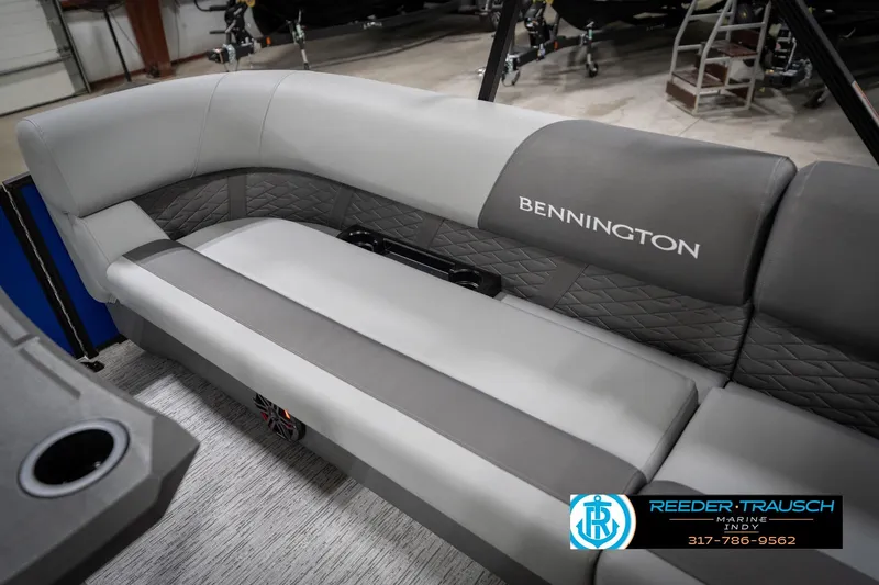 Slide: The Image of 2026 Bennington 25 SSR boat interior with gray seating and quilted accents. - 42