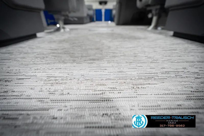 Slide: The Image of 2026 Bennington 25 SSR interior flooring with textured design, featuring Reeder-Trausch Marine logo. - 48