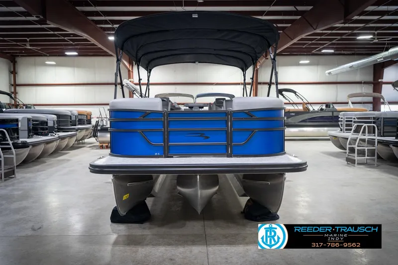 Slide: The Image of 2026 Bennington 25 SSR pontoon boat in showroom, blue exterior, under canopy. - 5