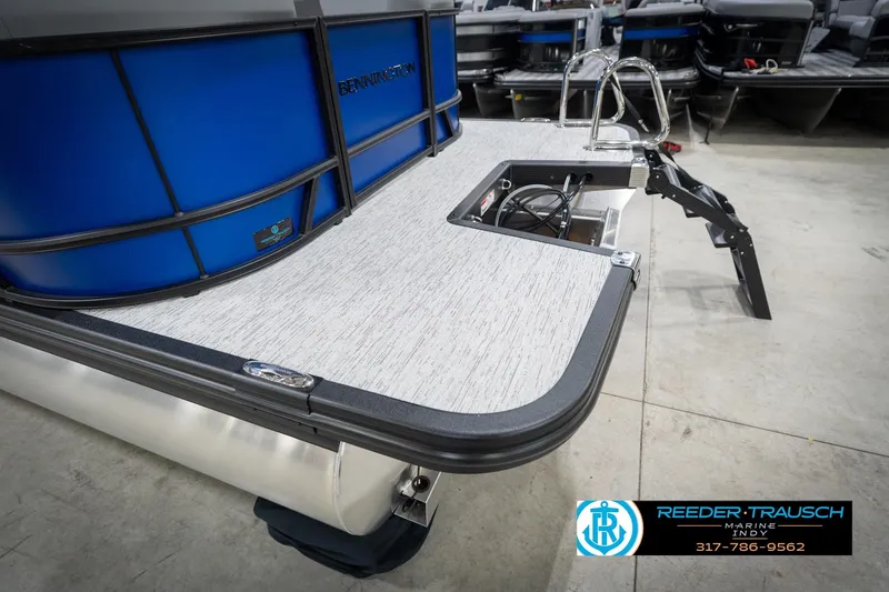 Slide: The Image of 2026 Bennington 25 SSR pontoon boat with blue exterior and deck ladder. - 52