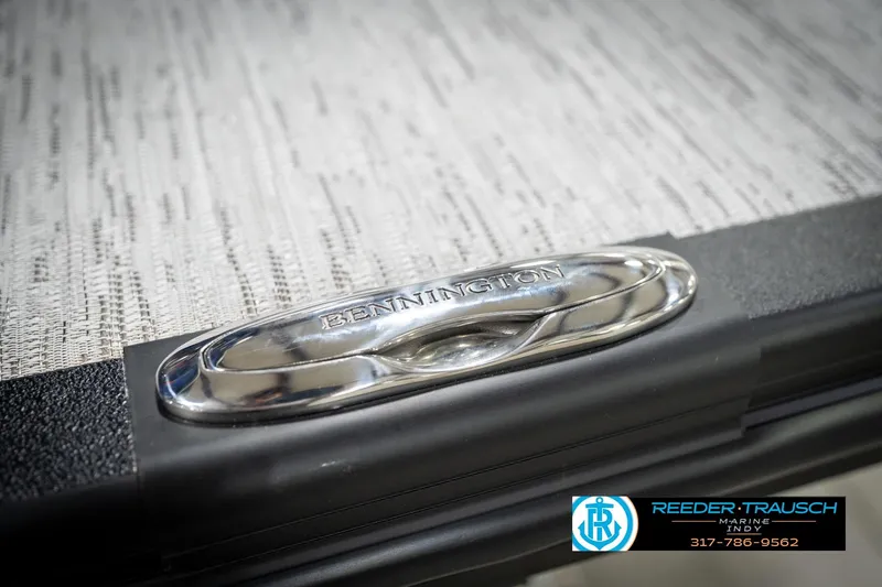 Slide: The Image of 2026 Bennington 25 SSR boat detail with logo and textured surface. - 53