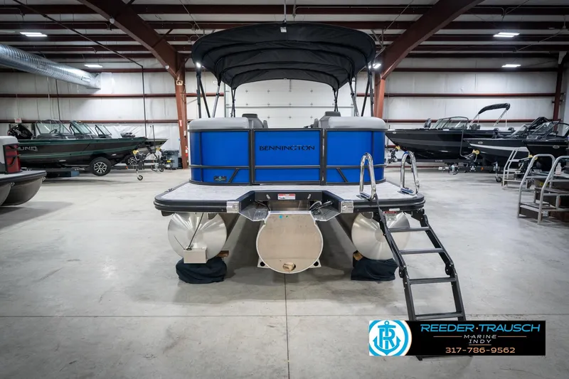 Slide: The Image of 2026 Bennington 25 SSR pontoon boat in showroom, featuring sleek design and modern amenities. - 9