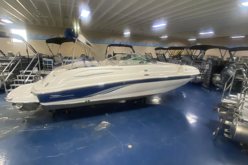 Slide: The Image of 2002 Chaparral Sunesta 243 boat displayed indoors on blue flooring. - 0