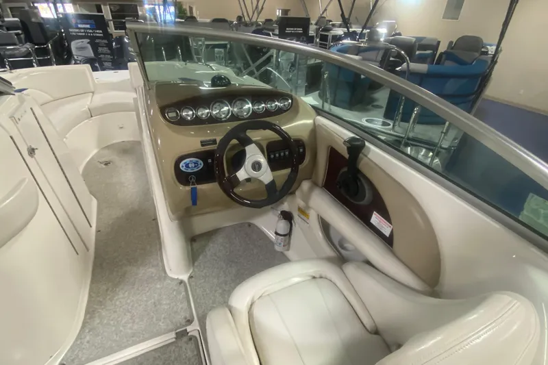 Slide: The Image of 2002 Chaparral Sunesta 243 boat interior with steering wheel and dashboard controls. - 4