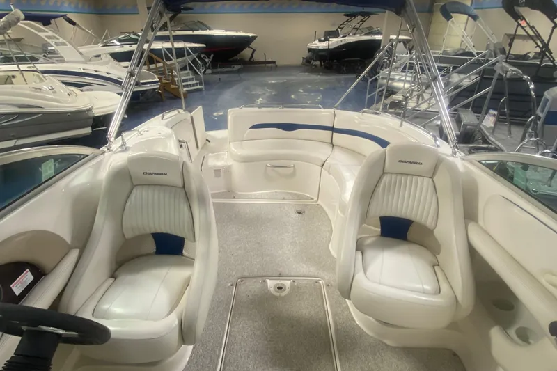 Slide: The Image of Interior of a 2002 Chaparral Sunesta 243 boat with white seating and steering wheel. - 6