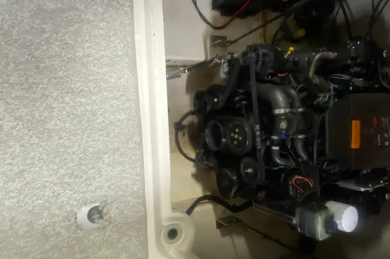 Slide: The Image of Engine compartment of a 2002 Chaparral Sunesta 243 boat, showcasing mechanical components. - 9