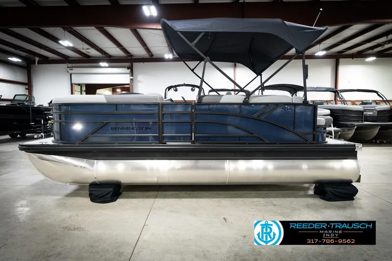 Slide: The Image of 2026 Bennington 188 SLJ boat interior with gray seating and steering console. - 11