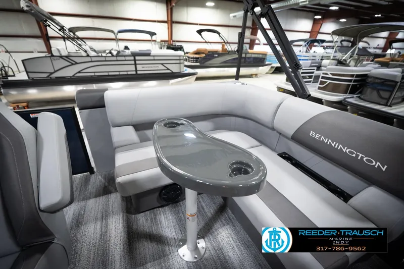 Slide: The Image of 2026 Bennington 188 SLJ pontoon boat interior with gray seating in showroom. - 23