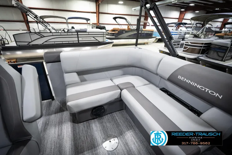Slide: The Image of 2026 Bennington 188 SLJ pontoon boat interior with gray seating in showroom. - 24