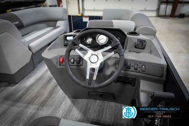 Slide: The Image of Close-up of 2026 Bennington 188 SLJ steering wheel with logo and Reeder-Trausch Marine contact. - 31