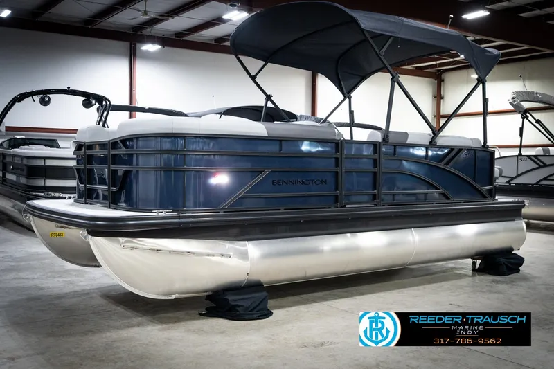 Slide: The Image of 2026 Bennington 188 SLJ pontoon boat displayed in a showroom with canopy. - 4