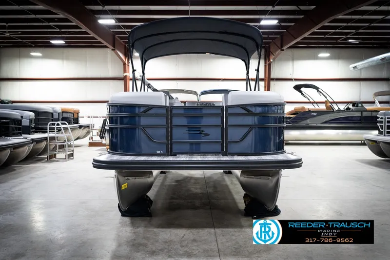 Slide: The Image of 2026 Bennington 188 SLJ pontoon boat in showroom with canopy and sleek design. - 5