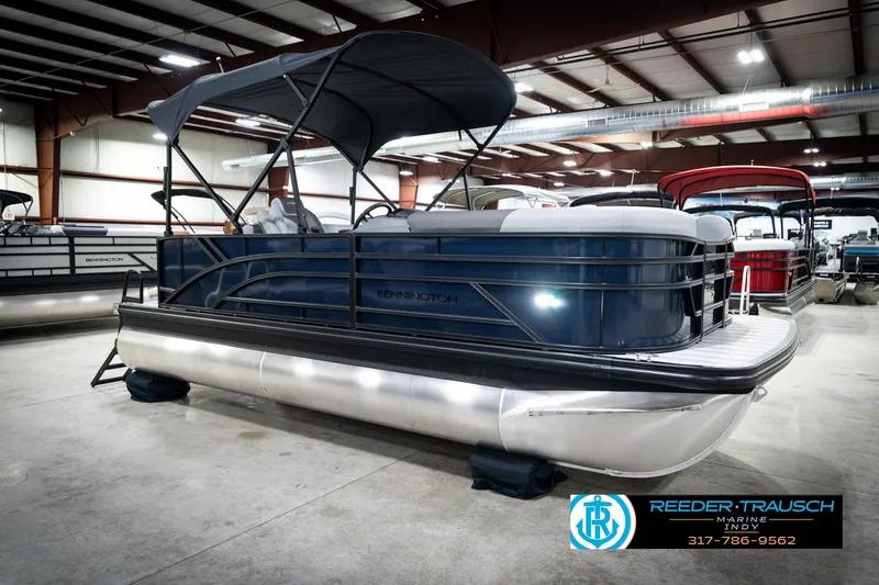Slide: The Image of 2026 Bennington 188 SLJ pontoon boat in showroom, featuring sleek design and canopy. - 6