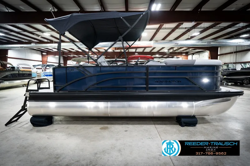 Slide: The Image of 2026 Bennington 188 SLJ pontoon boat in showroom, featuring sleek design and modern amenities. - 7