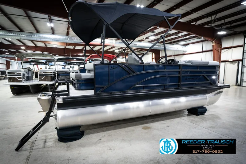 Slide: The Image of 2026 Bennington 188 SLJ pontoon boat in showroom with canopy and seating. - 8