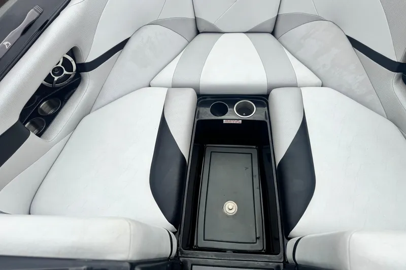 Slide: The Image of 2015 Centurion Enzo FS44 boat interior with cup holders and storage compartment. - 13