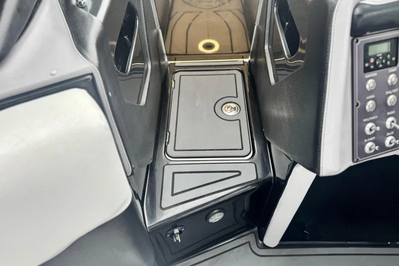 Slide: The Image of 2015 Centurion Enzo FS44 boat dashboard with control panel and storage compartment. - 14