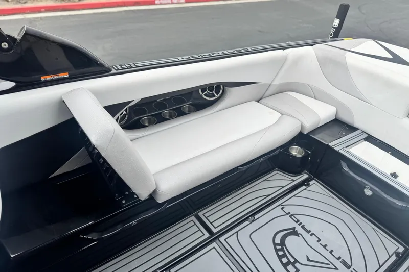 Slide: The Image of 2015 Centurion Enzo FS44 boat interior with white seating and cup holders. - 22