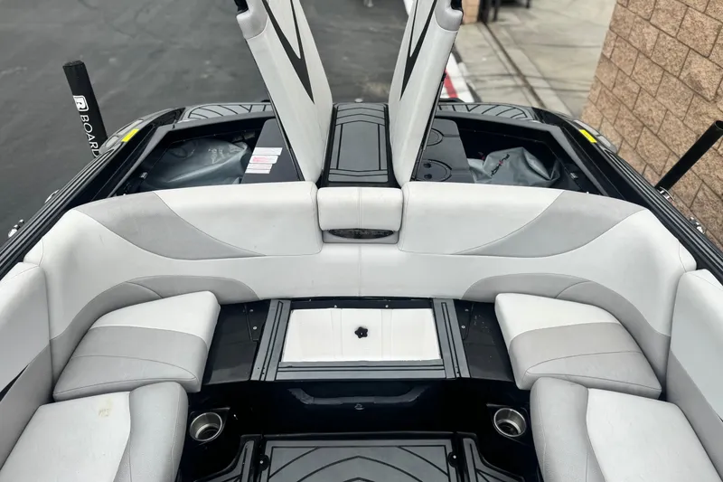 Slide: The Image of 2015 Centurion Enzo FS44 boat interior with white seating and open storage compartments. - 25