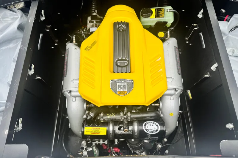 Slide: The Image of 2015 Centurion Enzo FS44 engine with yellow cover, PCM branding visible. - 28