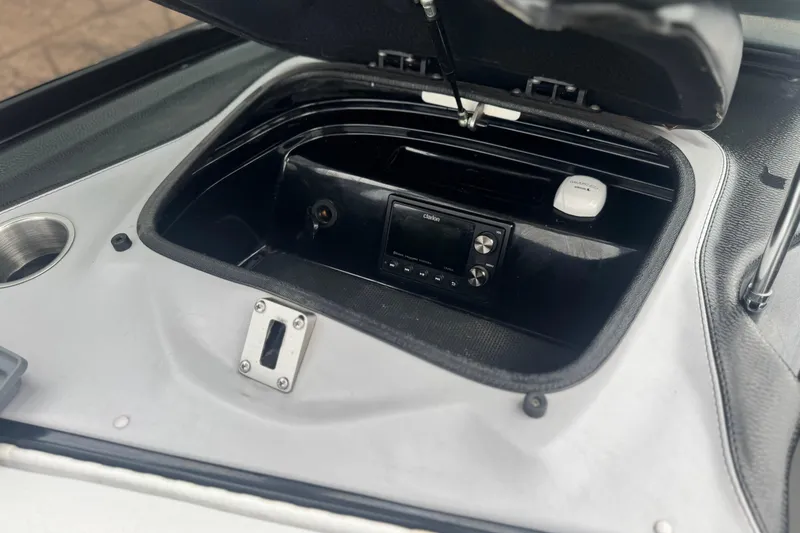 Slide: The Image of 2015 Centurion Enzo FS44 boat dashboard with Clarion audio system and storage compartment. - 32