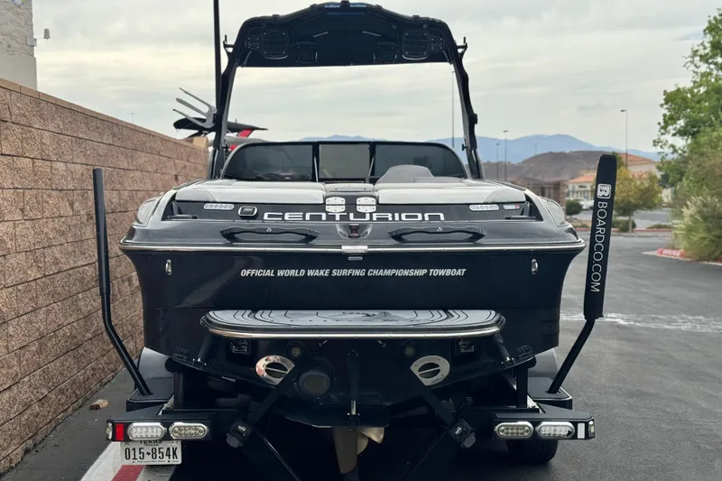 Slide: The Image of 2015 Centurion Enzo FS44 boat, rear view, parked on a street with mountains in background. - 4