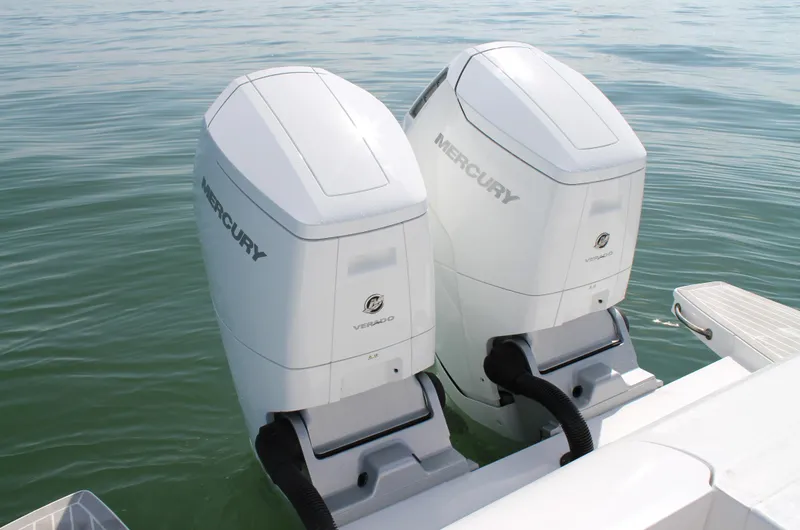 Slide: The Image of Twin Mercury outboard engines on a 2024 Intrepid 41 Valor boat in calm waters. - 11