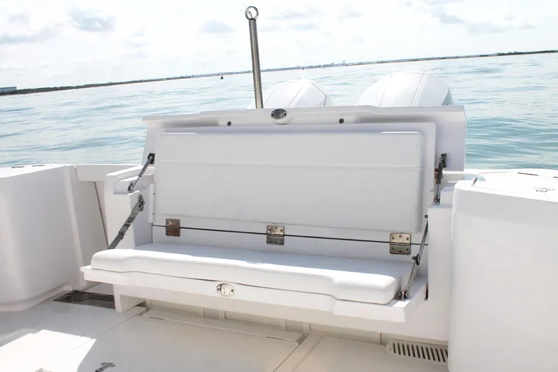 Slide: The Image of 2024 Intrepid 41 Valor boat with open rear seating, ocean backdrop. - 14