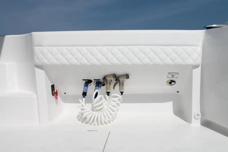 Slide: The Image of 2024 Intrepid 41 Valor boat deck with coiled hose and utility panel. - 16