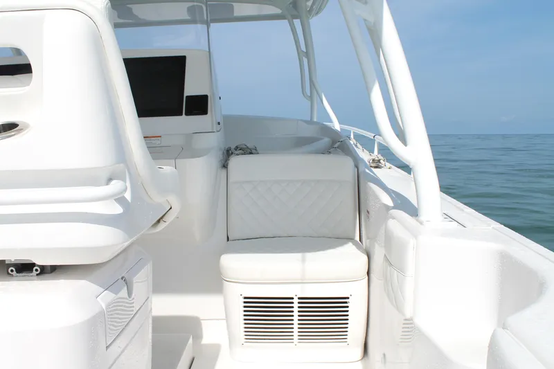 Slide: The Image of 2024 Intrepid 41 Valor boat interior with white seating and ocean view. - 17