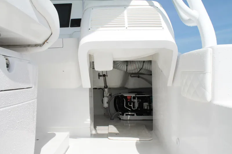 Slide: The Image of 2024 Intrepid 41 Valor boat interior, showcasing engine compartment and sleek white design. - 18