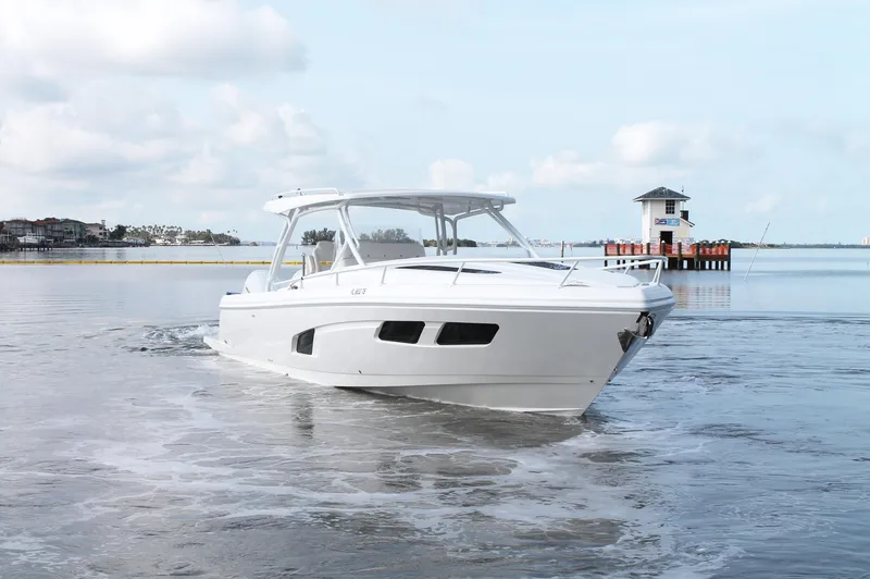Slide: The Image of 2024 Intrepid 41 Valor boat cruising on calm water under a cloudy sky. - 2