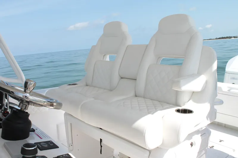 Slide: The Image of 2024 Intrepid 41 Valor boat with luxurious white seating and ocean backdrop. - 21