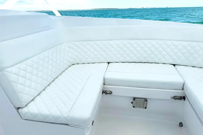 Slide: The Image of Luxurious white seating on 2024 Intrepid 41 Valor boat, overlooking the ocean. - 22