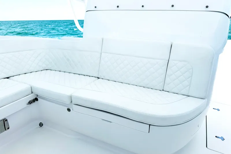 Slide: The Image of Luxurious white seating on 2024 Intrepid 41 Valor boat with ocean backdrop. - 24