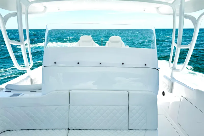 Slide: The Image of 2024 Intrepid 41 Valor yacht interior with ocean view, featuring luxurious white seating. - 25