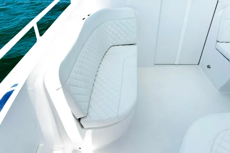 Slide: The Image of Luxurious white seating on 2024 Intrepid 41 Valor boat, with quilted upholstery and ocean view. - 26