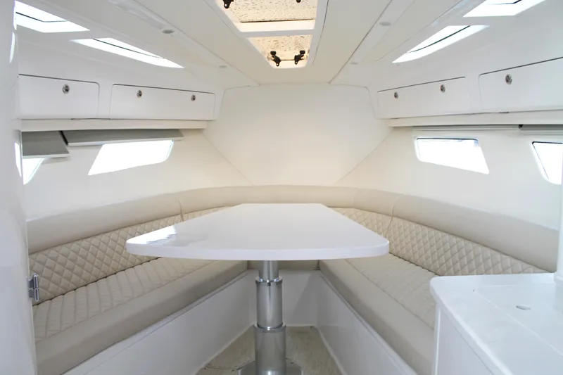 Slide: The Image of 2024 Intrepid 41 Valor interior with white seating and table, featuring modern design and ample lighting. - 29