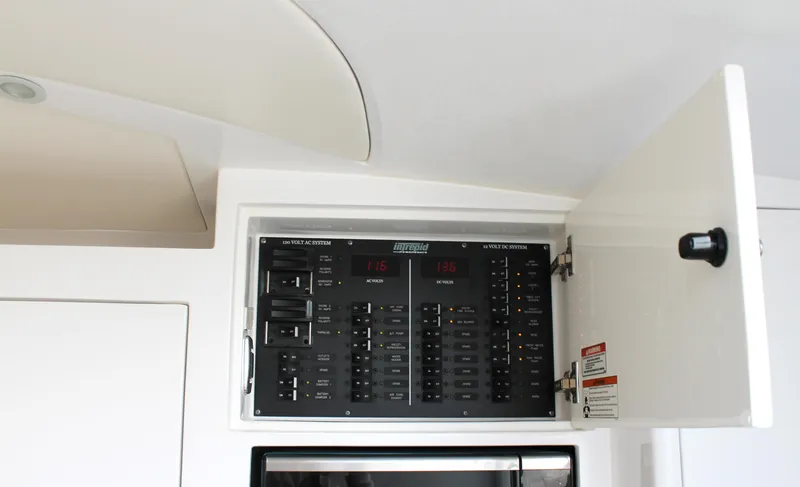 Slide: The Image of Electrical panel inside 2024 Intrepid 41 Valor boat, showcasing circuit breakers and controls. - 31