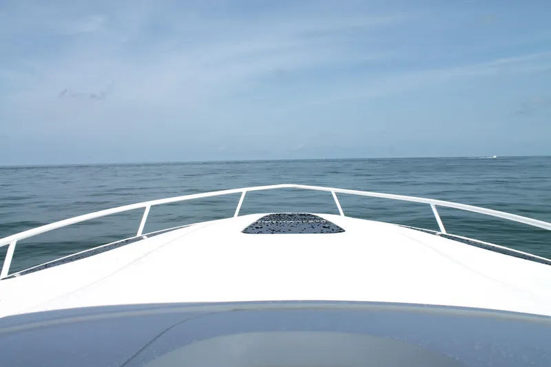 Slide: The Image of 2024 Intrepid 41 Valor boat bow on open sea under clear sky. - 33