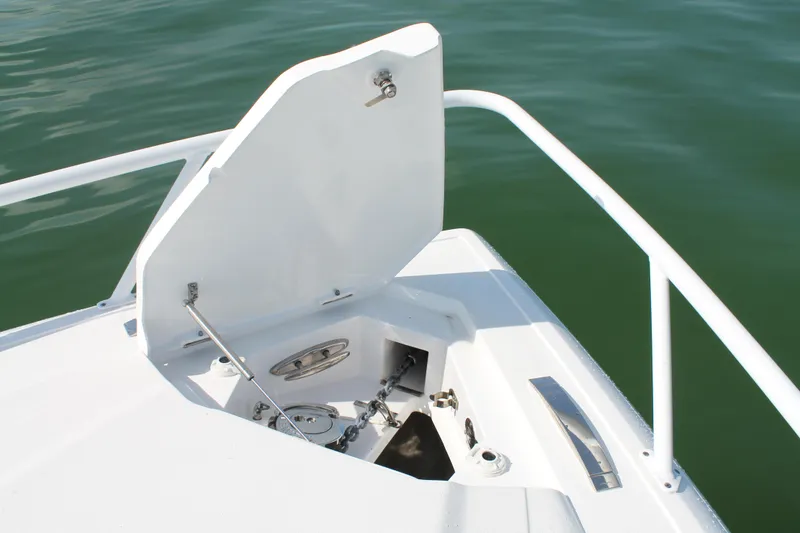Slide: The Image of 2024 Intrepid 41 Valor boat anchor compartment with open hatch, showcasing marine hardware. - 36