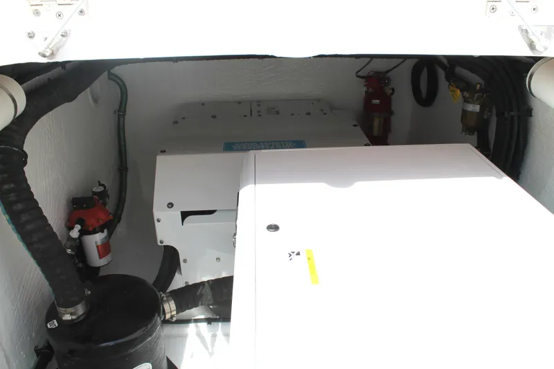 Slide: The Image of Engine compartment of 2024 Intrepid 41 Valor boat, showcasing mechanical components and safety equipment. - 38