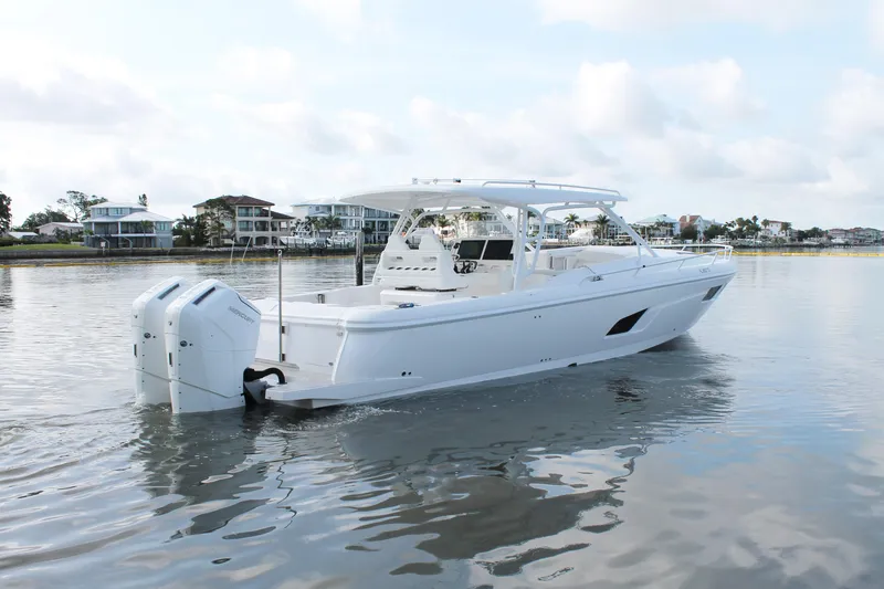Slide: The Image of 2024 Intrepid 41 Valor boat on calm water, showcasing sleek design and powerful engines. - 4