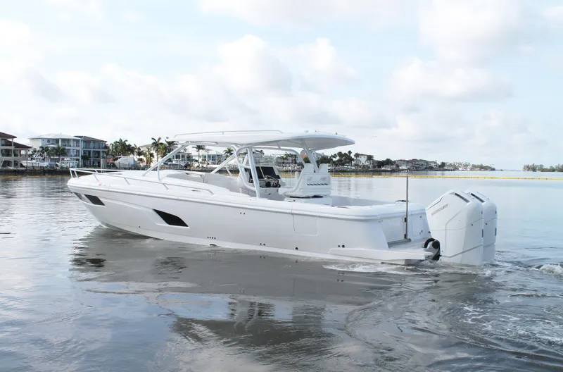 Slide: The Image of 2024 Intrepid 41 Valor boat on calm water, showcasing sleek design and powerful engines. - 5