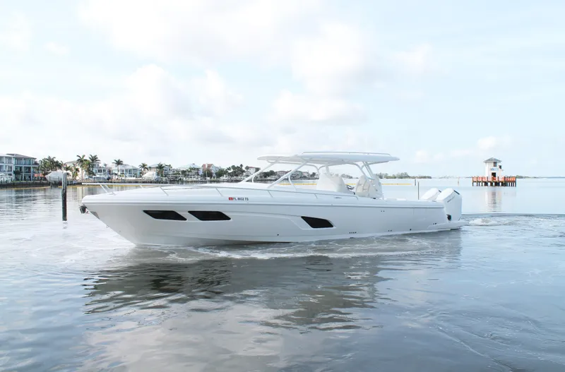 Slide: The Image of 2024 Intrepid 41 Valor boat cruising on calm waters, showcasing sleek design and luxury features. - 7