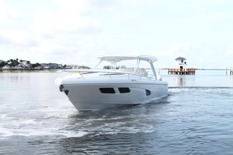 Slide: The Image of 2024 Intrepid 41 Valor boat cruising on calm waters near a coastal area. - 8