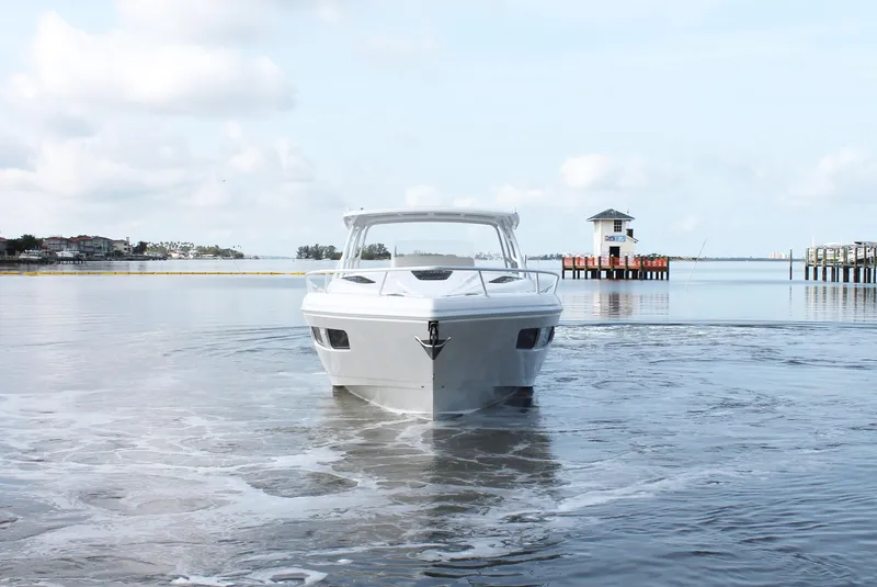 Slide: The Image of 2024 Intrepid 41 Valor boat on calm water with scenic background. - 9